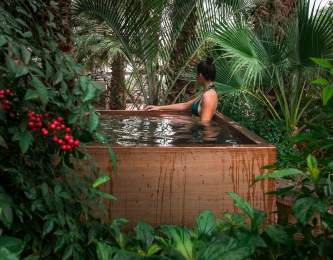 Woman relaxing in hot mineral pool at Two Bunch Palms resort in Desert Hot Springs