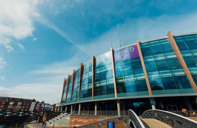 Exterior of Utilita Arena Birmingham under a blue sunny sky