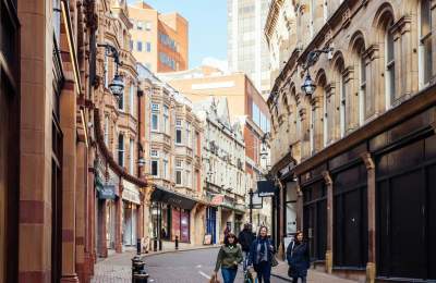 A view along Canon Street, with shops on either side, during the day