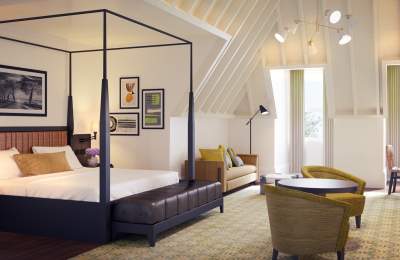 The Grand Hotel luxury suite, featuring a canopy bed, table and two chairs