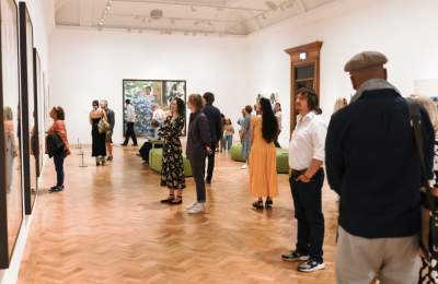 people in a gallery looking at paintings