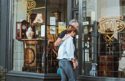 Couple looking through the window of an antique shop in Old Town Bridlington