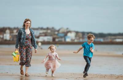A family walking along Bridlington Beach in East Yorkshire