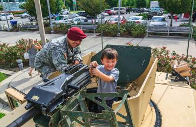 American Soldier enjoying child's reaction at National Airborne Day event
