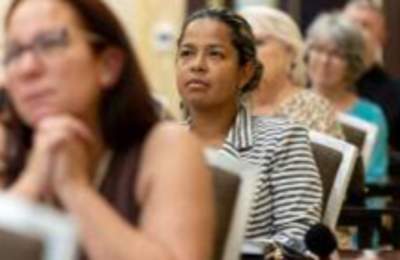 Image of people attending a meeting at the Embassy Suites Fayetteville