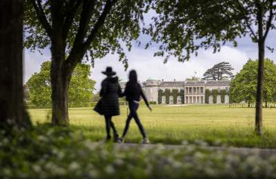 People walking across Goodwood Estate with Goodwood house in back ground