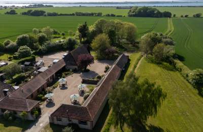 Aerial view of Canute Cottages with Chichester Harbour in the distance