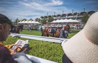 People and racehorses at Goodwood Racecourse