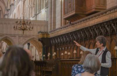 a tour guide leading a group at Chichester Cathedral