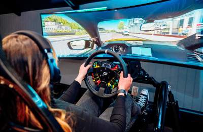 A picture showing a person in a race simulator