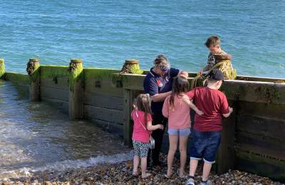 A group of children on a beach with waves coming in