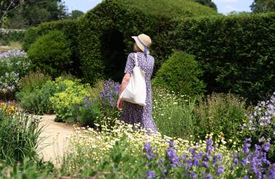 a person walking in formal gardens