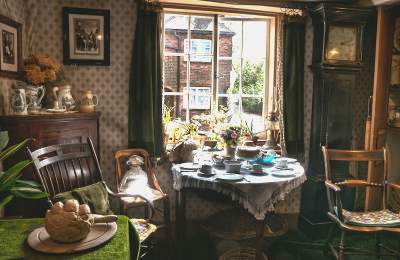 image shows a living room set up as though in the 1900s