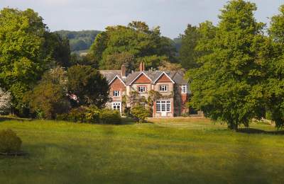 A view of a country house in woodlands