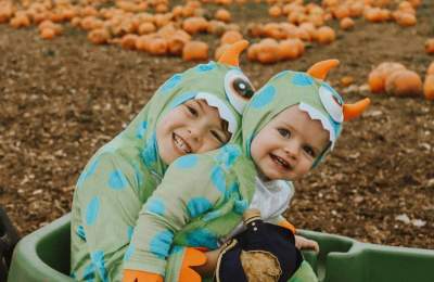 Children in fancy dress in pumpkin patch