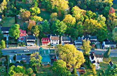 Aerial of Hillsboro, Virginia's tree-lined main street and historic homes amid fall foliage in western Loudoun