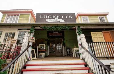 Exterior of Lucketts antique store decorated with holiday garland in Lucketts, Virginia.