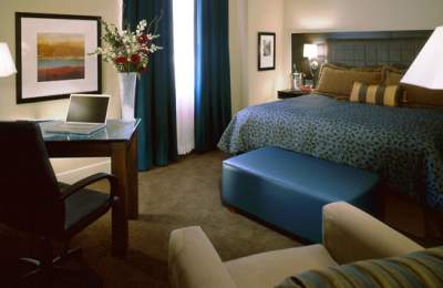 Attractive Hotel Room with Bed, Desk, Chair, and Window