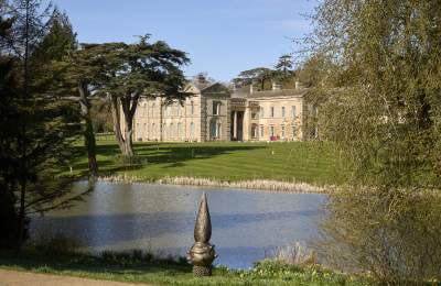 A view of Compton Verney on a clear day from across the lake