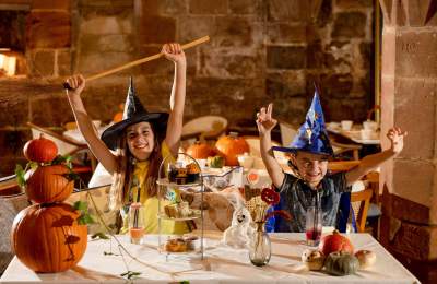 Children in Halloween Costumers enjoying afternoon tea