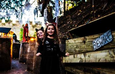 Two children in Halloween fancy dress smiling and enjoying Warwick Castle