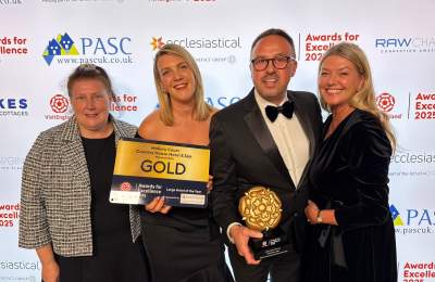 Four people holding an award for VisitEngland Best Large Hotel of the Year 2025 and smiling at the camera.