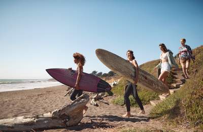 Friends on beach with surf boards