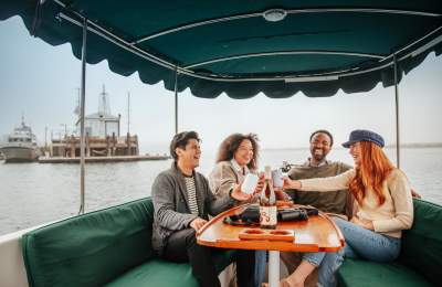 friends enjoying drinks on a harbor cruise around Morro Bay