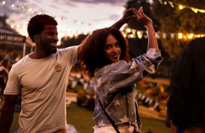 Couple dancing with lights in background