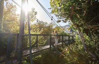 Couple Walking across swinging bridge in Arroyo Grande