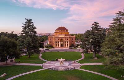 Atascadero City Hall with gardens and fountain in front at sunset