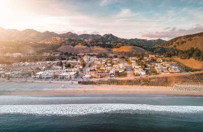 Aerial view of Avila Beach surrounded by mountains at golden hour