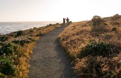 Couple walking trail on Fiscalini Ranch Preserve in Cambria