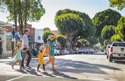 Family of four walking across a street in Downtown San Luis Obispo
