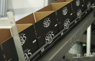 Boxes on assembly line with 805 printed on them