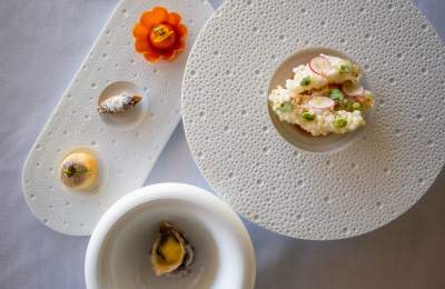 Three white dishes with tasting dishes