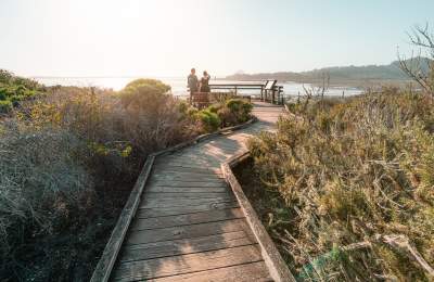 Couple walking on the Los Osos & Baywood Boardwalk