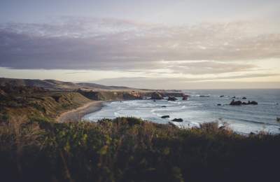 View of coast with ocean and green hills