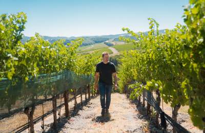 Owner Andy Niner walking through vineyard at Niner Wine Estates