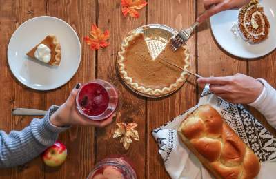 Overview of a fall holiday table with Pumpkin Pie and leaves