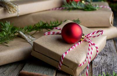 Gifts wrapped with red ornaments and greenery