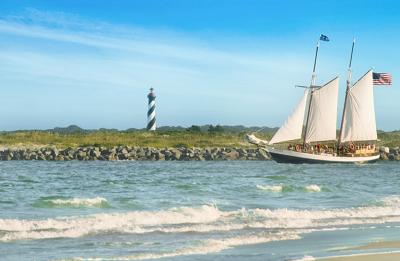 Schooner Freedom Sailing through the inlet with the St. Augustine Lighthouse in the background