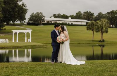 Bride and Groom on Island with venue behind