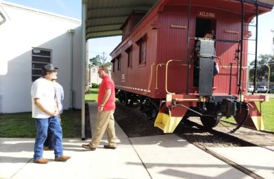 Visitors at the old red wooden caboose