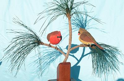 Cardinals in pine bough - wood carving by Bill Moon