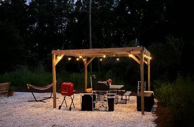 12x12 Shade Structure houses kitchen, cart, grill, picnic table and wood storage