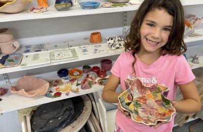 A Camper shows off the beautiful bowl she made in Clay Camp!