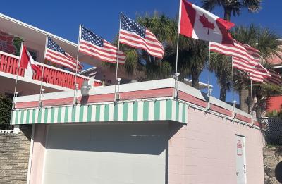 US and Canadian Flags Proudly Displayed at Tropical Manor
