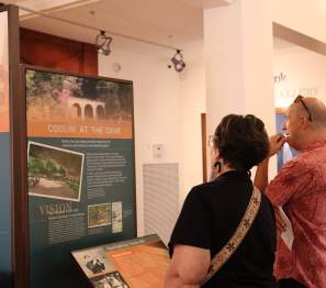 man and woman view a display at a museum