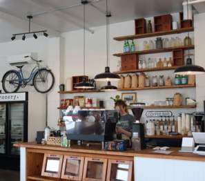 woman stands behind counter at local cafe